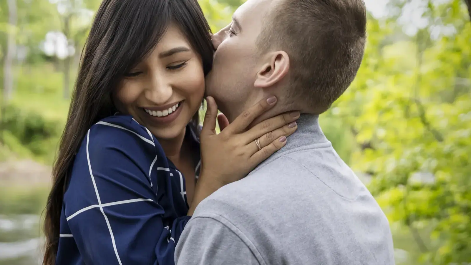 Couple in a close embrace with their faces filling the frame, the kind of tight portrait that reads well on a card